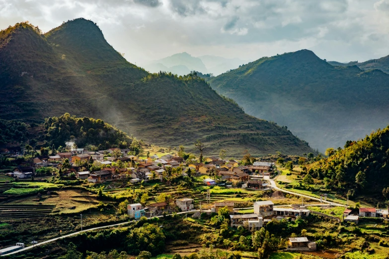 the mountains surrounding a small town with houses on top