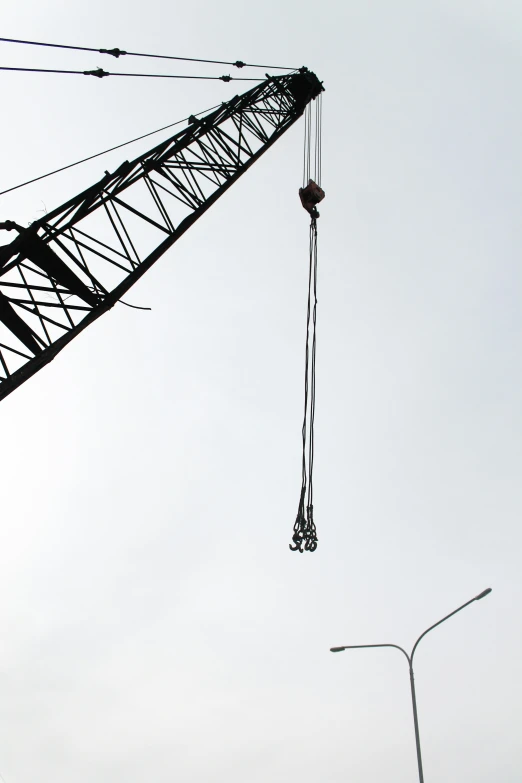 a crane that is suspended by cables on it