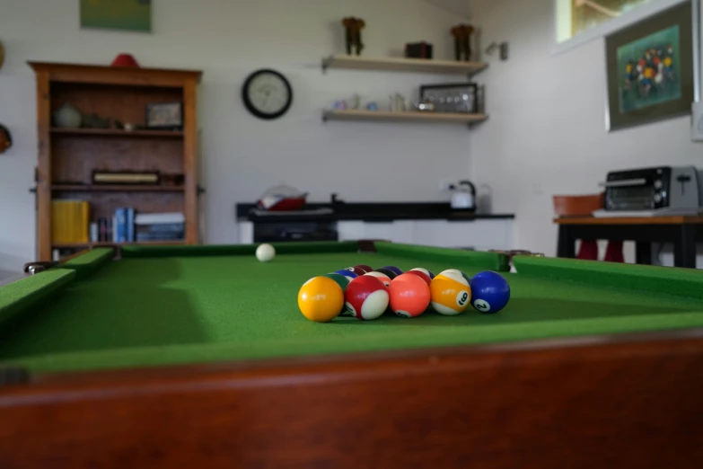 a billiards game in progress as the players return to their resting place