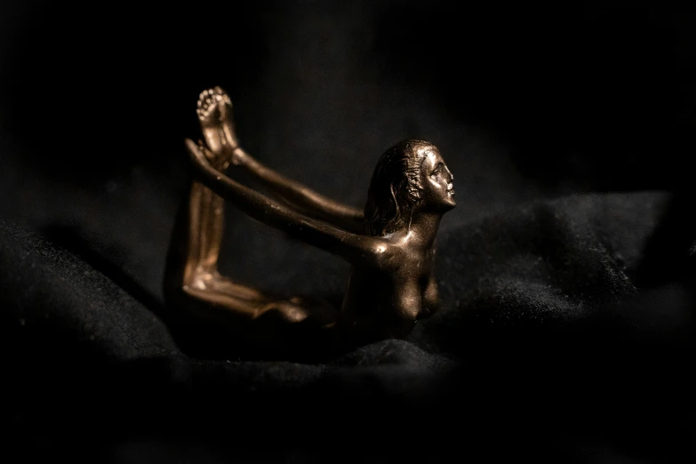a small gold sculpture of a human torso