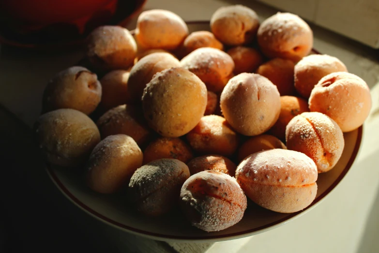 a bowl of donuts on top of a table