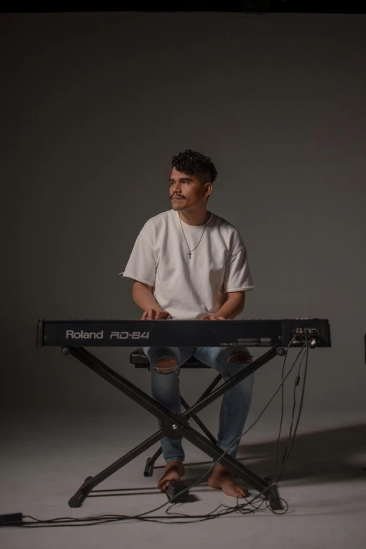 a man sitting at a keyboard playing a musical instrument