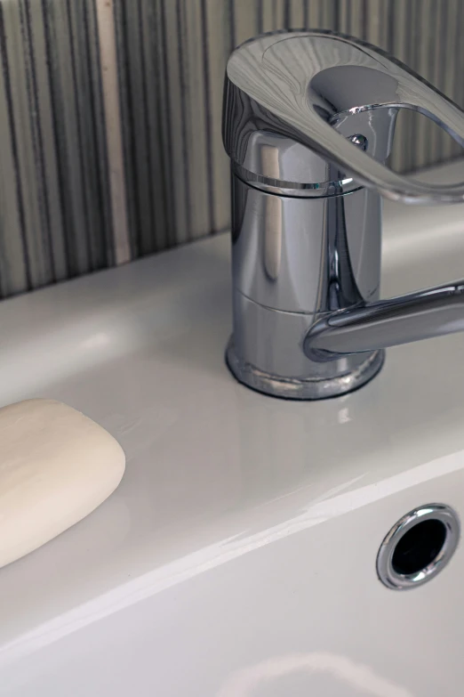 a bathroom faucet that is on the sink