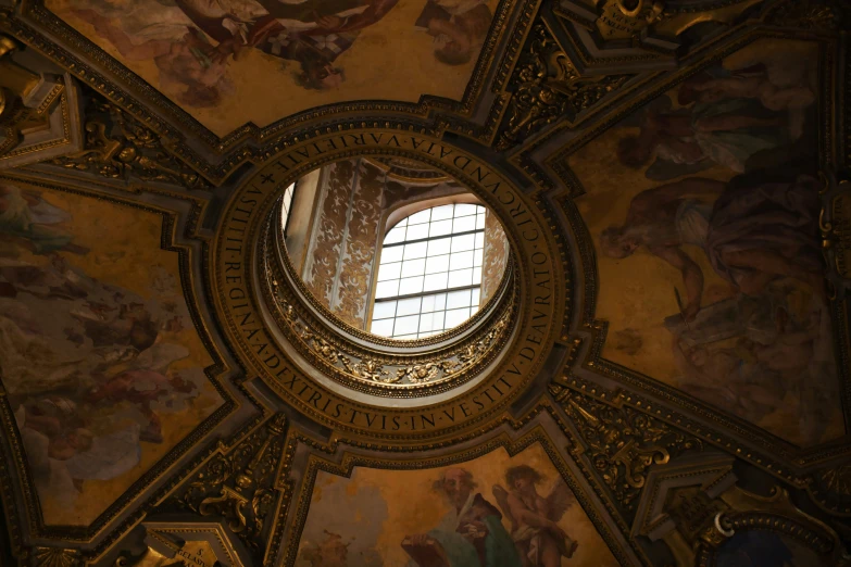 a small window is above an elaborate painted ceiling