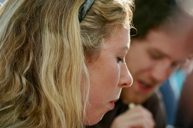 a close up of a person eating soing from a spoon