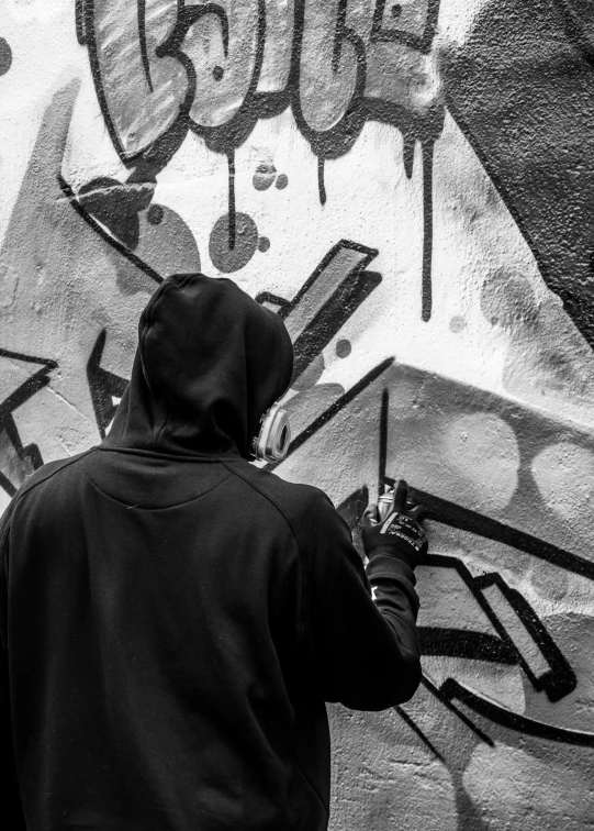 a person painting graffiti on the side of a building