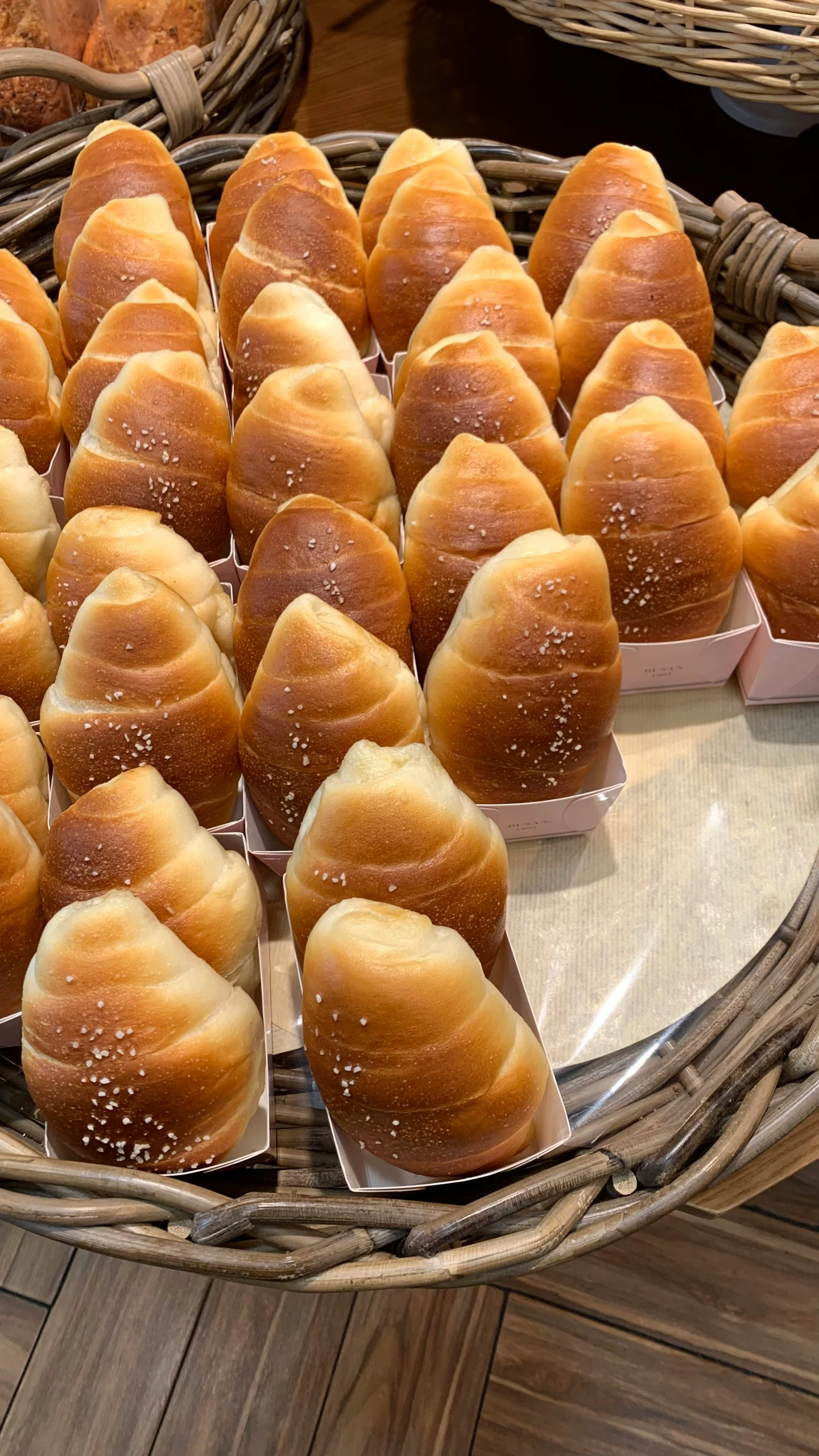 rolls and baked goods in baskets in the shop