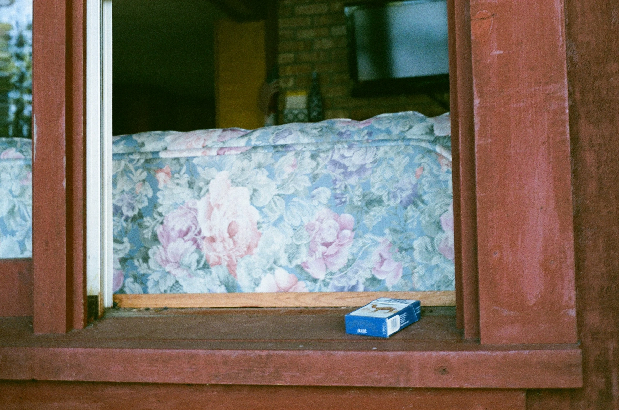 blue and white box on a window sill in a house