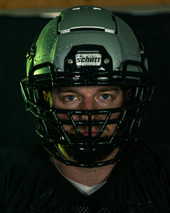 a man in football helmet looking at the camera