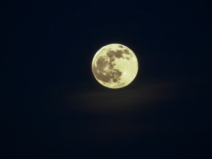 the moon is almost obscured by a black night sky