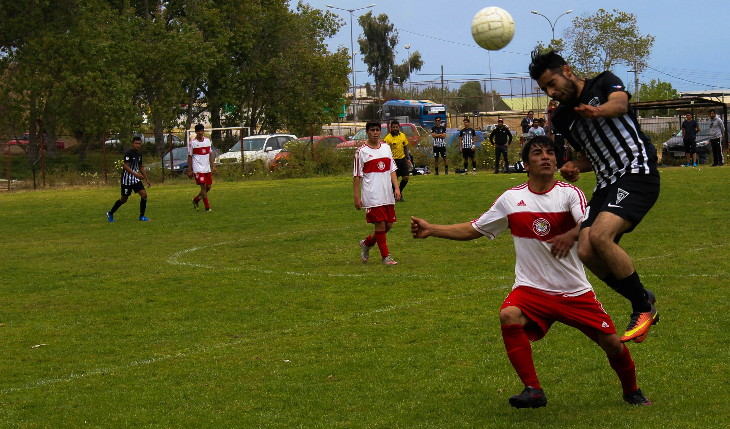 a soccer game with two teams competing for the ball