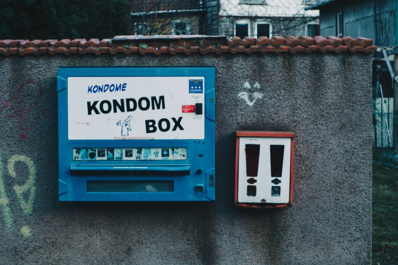 a blue and white nintendo video game sitting on the side of a building