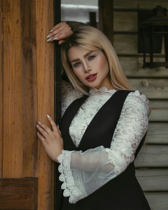 a woman that is leaning up against a door