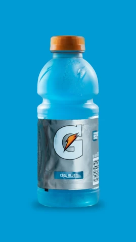 a bottle of gatorade water on a blue surface