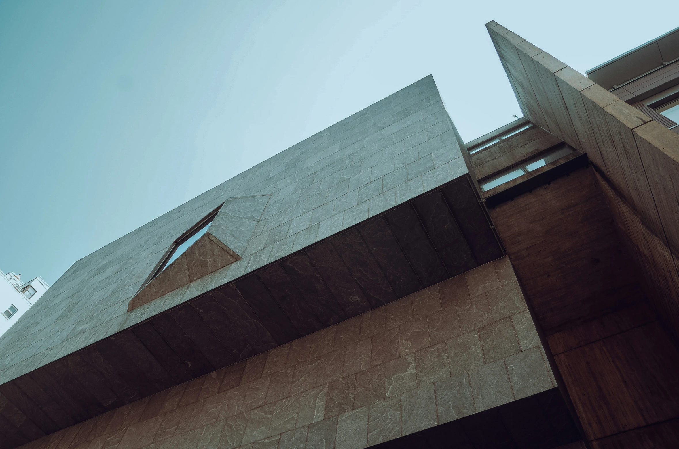 an upward view of concrete structure with a blue sky