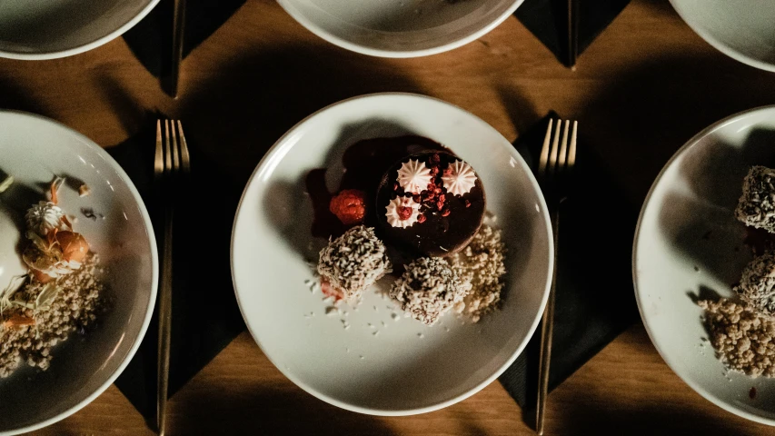 a plate has four different types of desserts