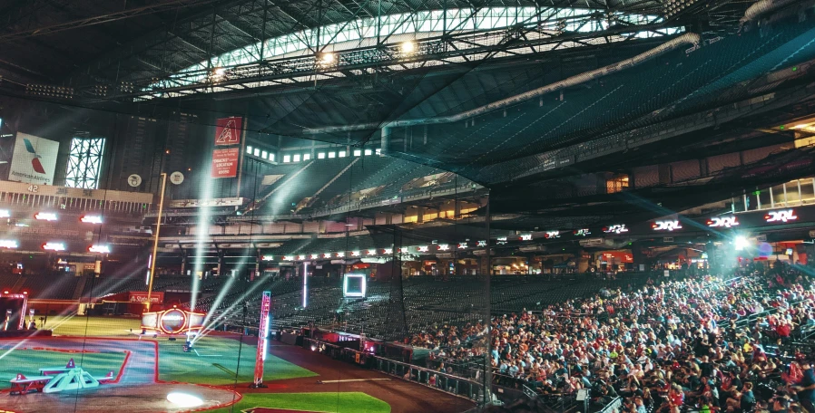 large group of people in a stadium at night