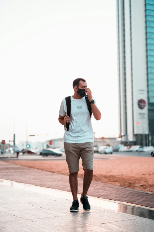 a person walks down the sidewalk while on their cell phone