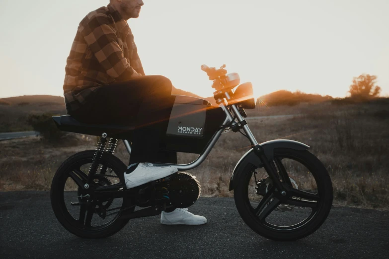 a man is sitting on a small motorcycle