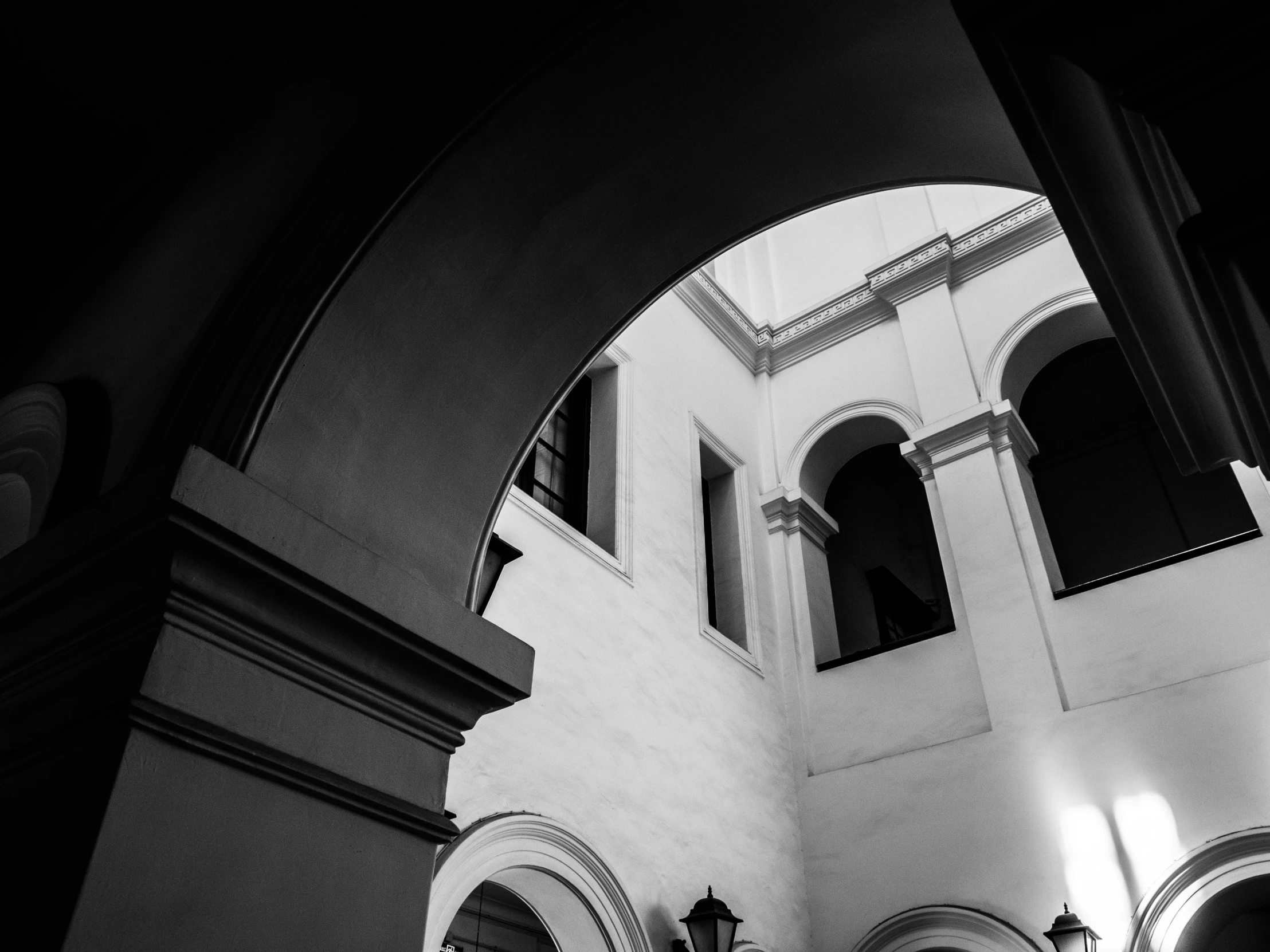 the interior of a church with arches and a clock