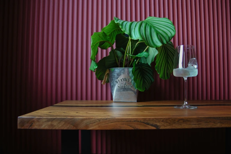 a table with an open silver vase and plant