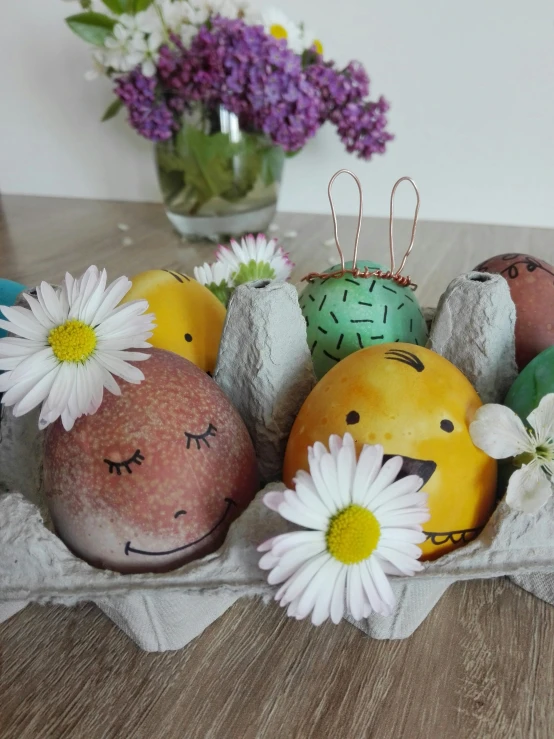 decorative rocks and daisies displayed with flowers