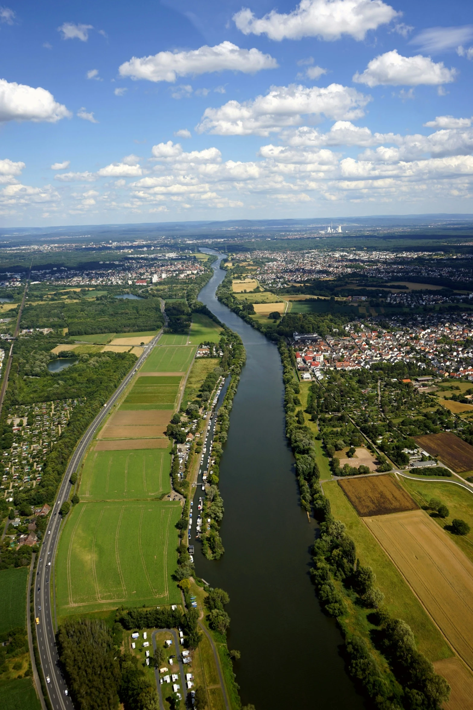 an aerial view of a waterway running along a countryside
