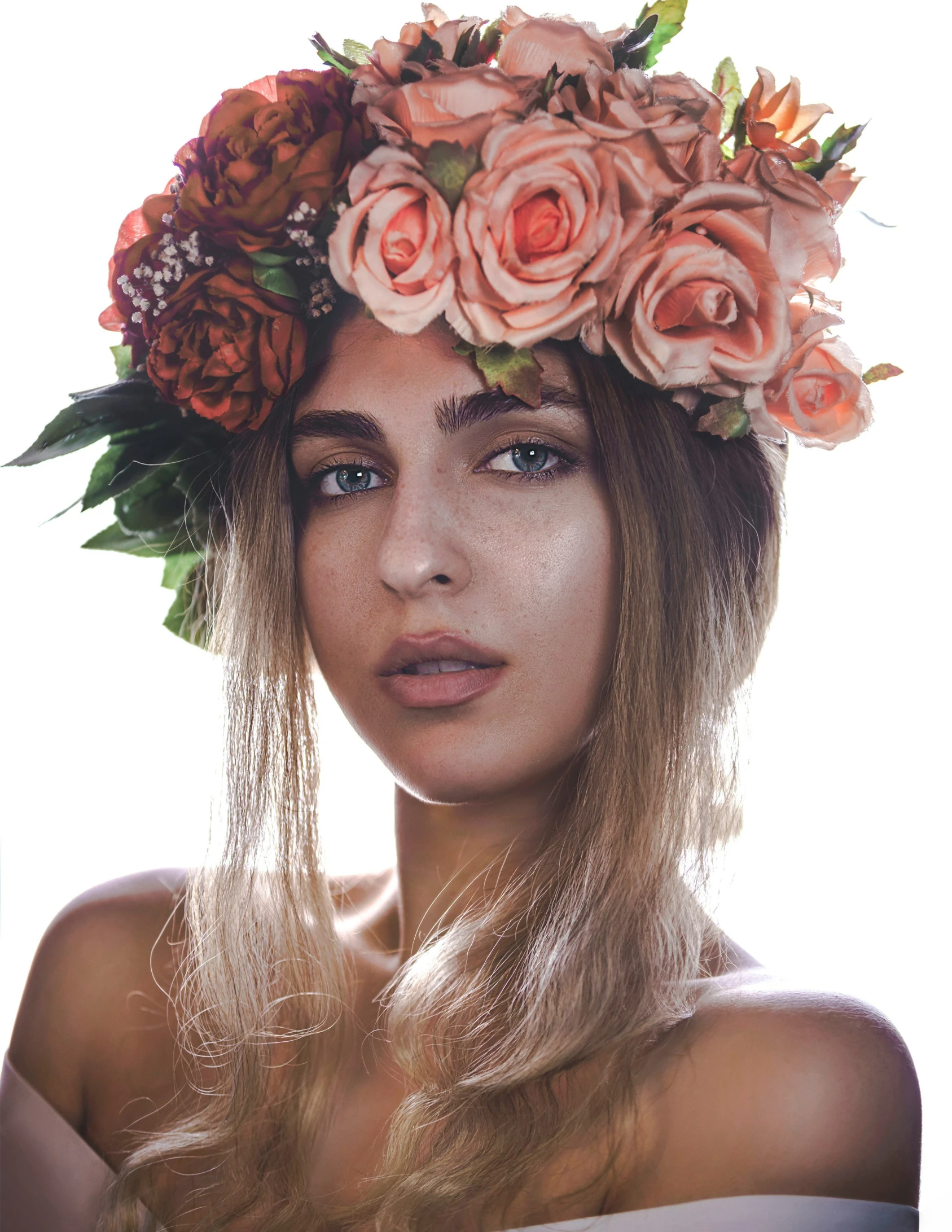 an attractive blond wearing a floral crown on her head