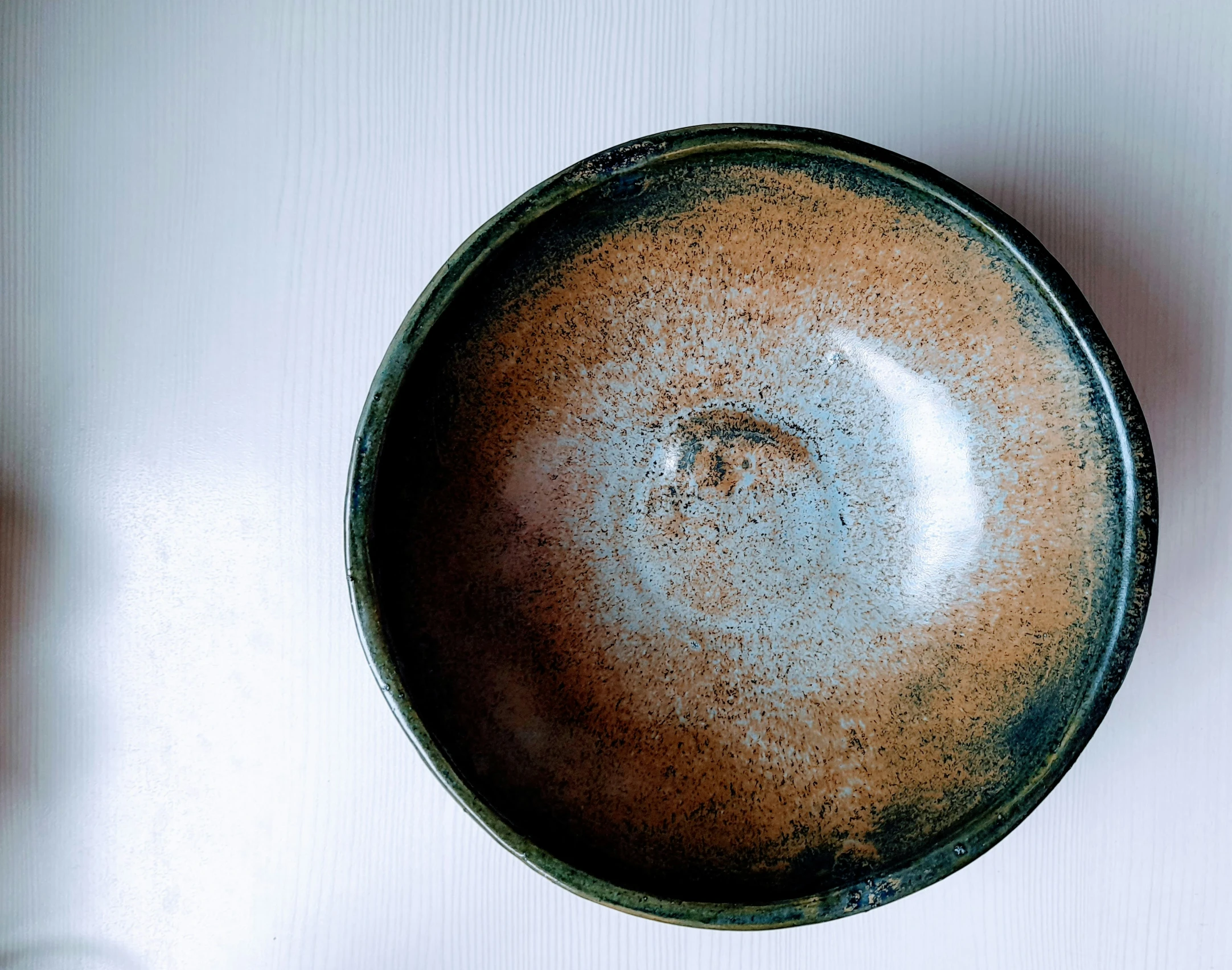 a brown bowl with some small holes in it