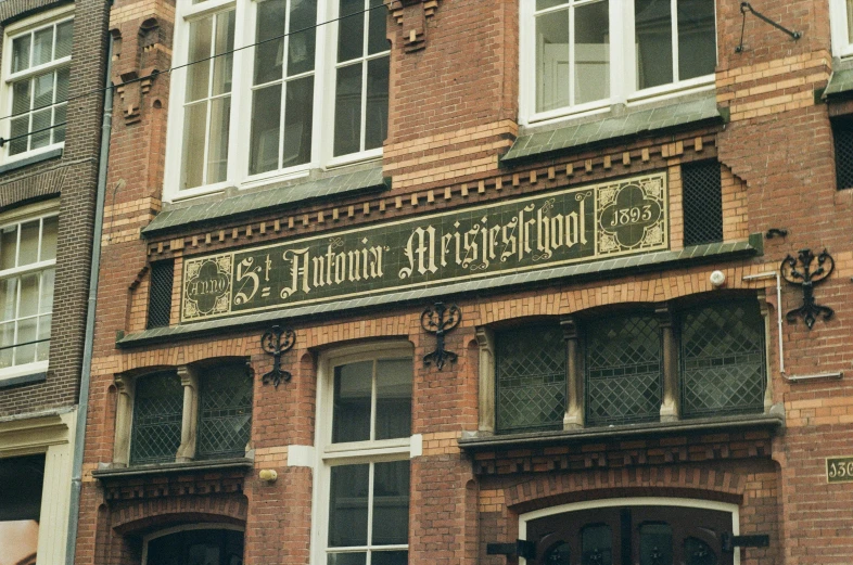 a tall brick building has large windows