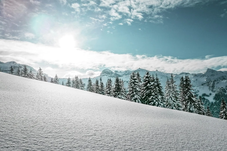 the sun is shining above the snowy mountains