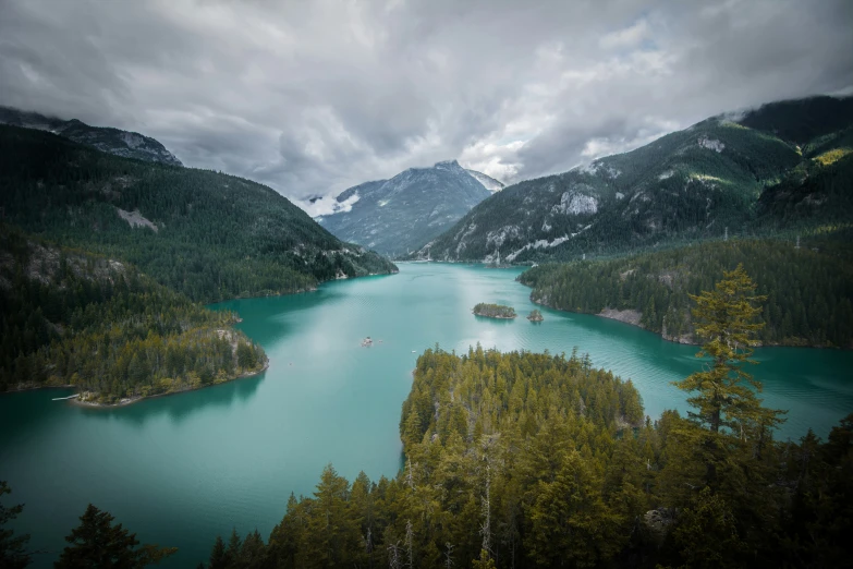 a beautiful lake surrounded by mountains and forest