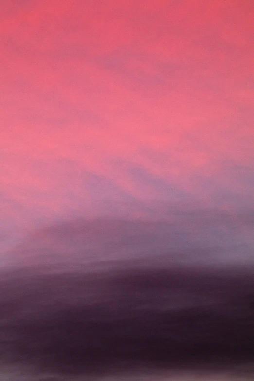 a blurry picture of a pink, purple, and gray sky