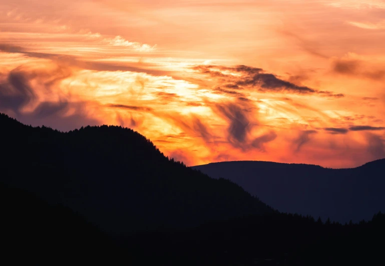 a view from the top of a hill at sunset