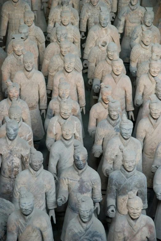 a large group of statues with different skin colors