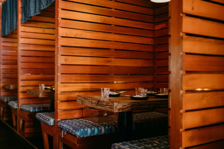 the restaurant has wood walls and wooden benches