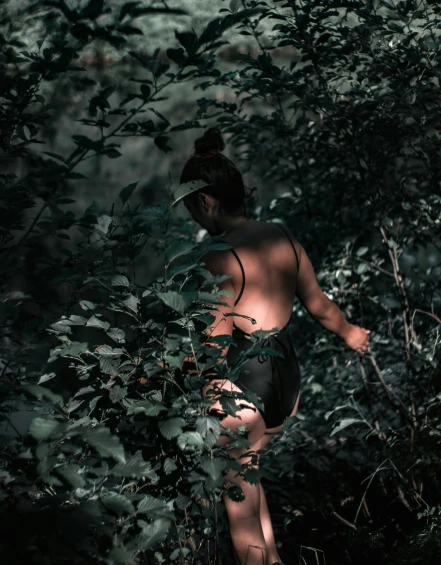 the  woman is walking in the woods