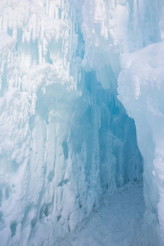 the inside of a frozen cave with water flowing through