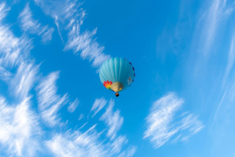 a  air balloon floating through the sky on clear day