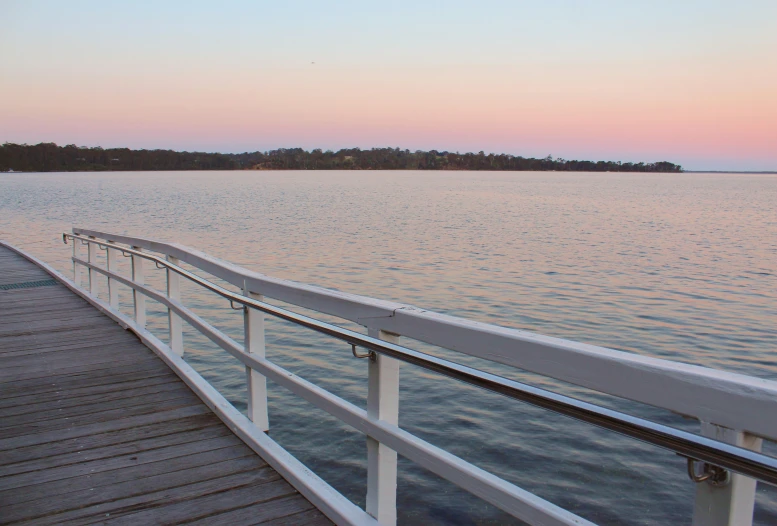 a long view of a pier at dusk