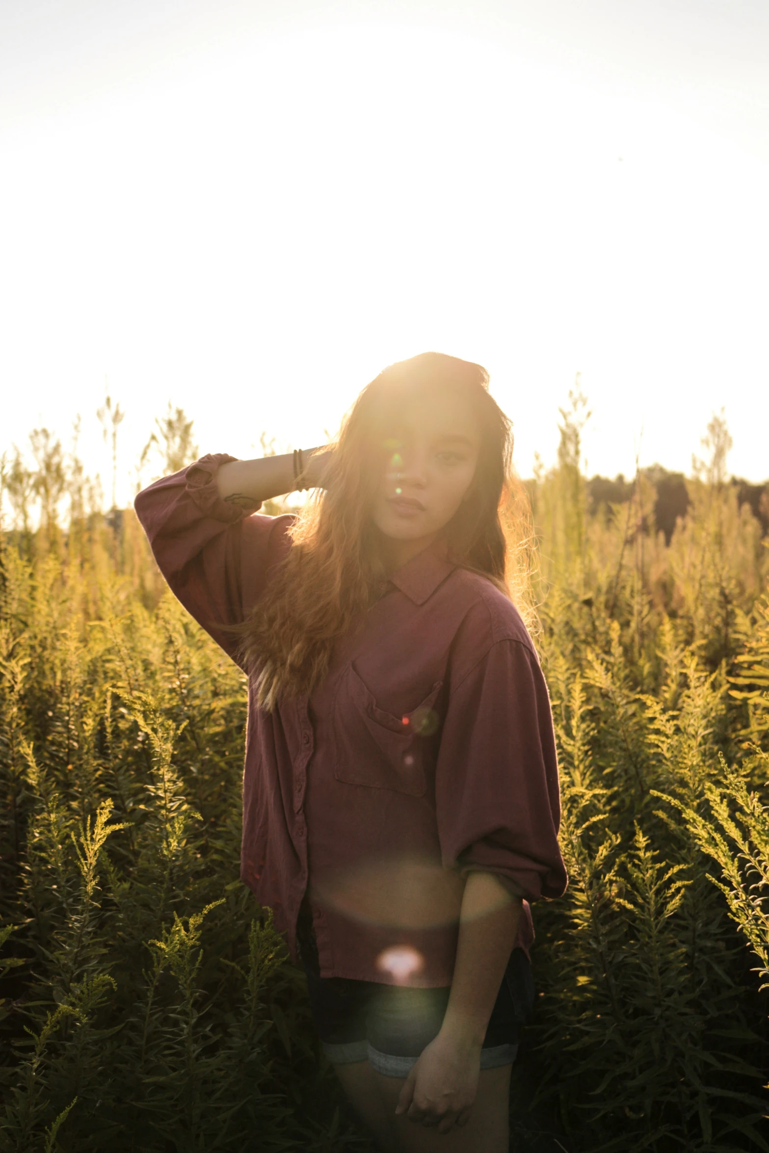 the young lady poses for a picture in the field