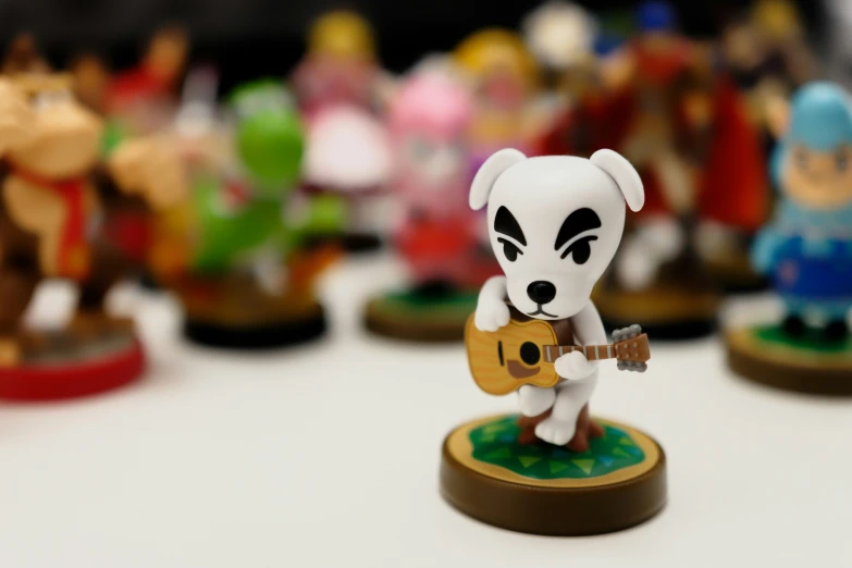 a toy dog with a guitar on the table