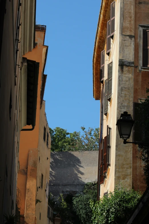 an alley way with a clock tower in the distance