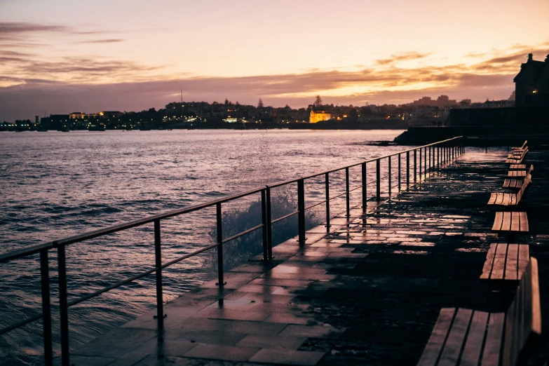 benches along a railing overlooking the water