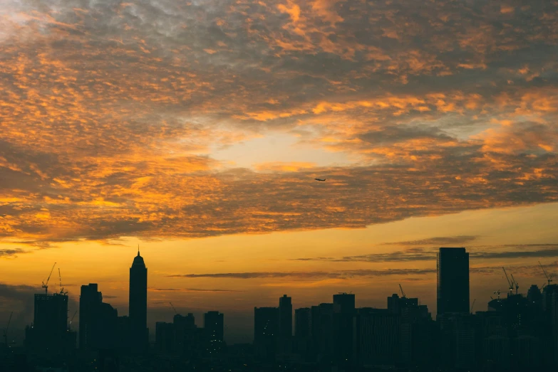 the city is shown with colorful clouds over it