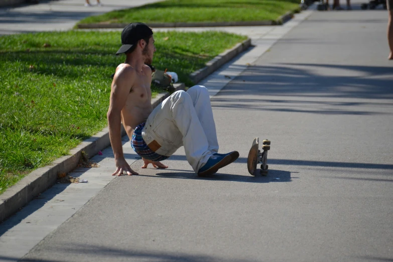 a man is skateboarding down a residential sidewalk