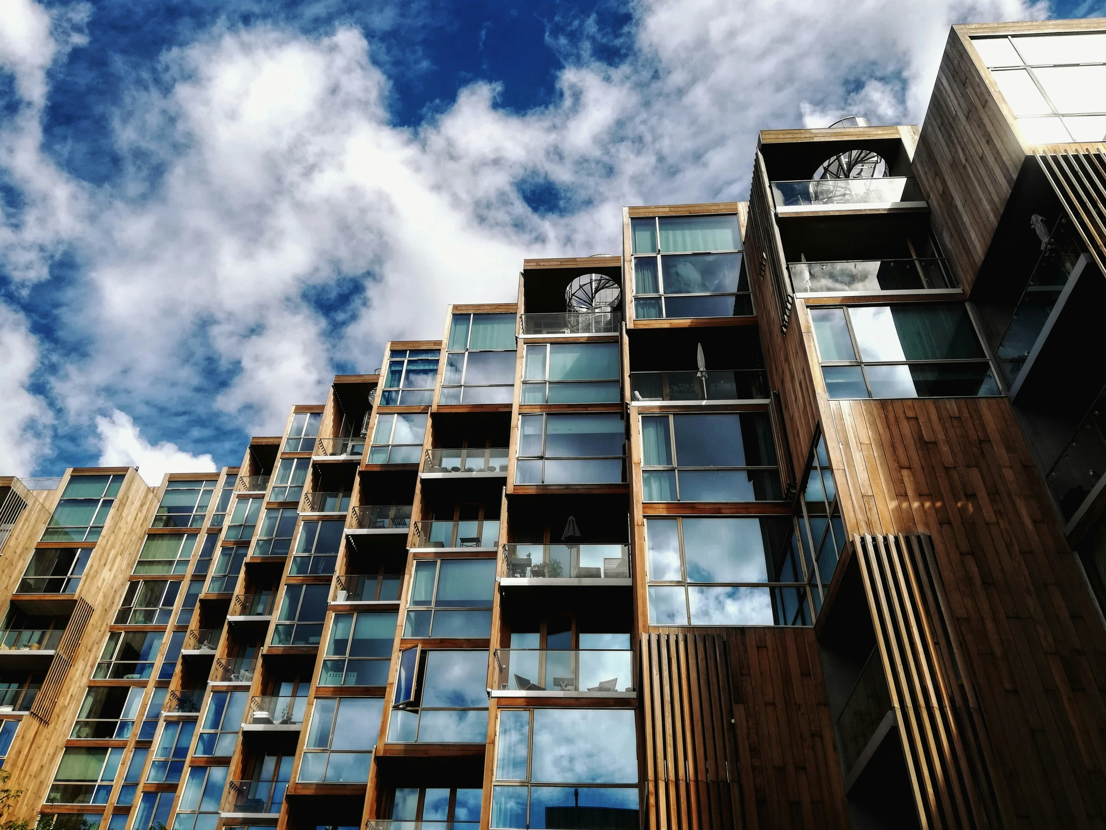 a tall building with windows and clocks on it