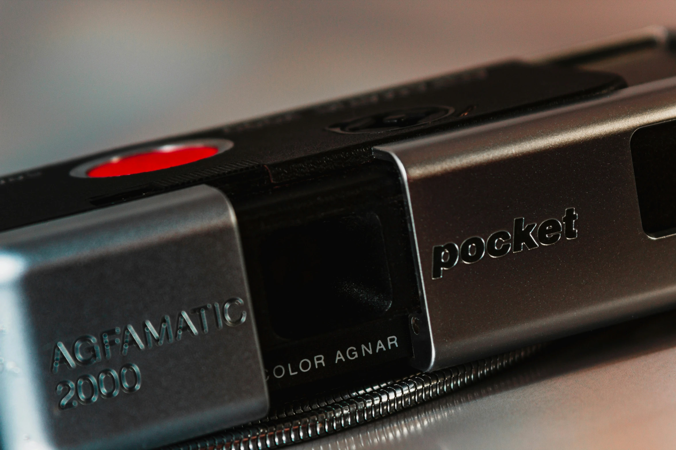 a black and silver camera sitting on top of a table