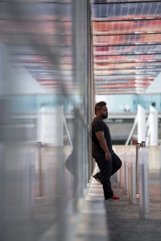 a man standing at a terminal holding a cane