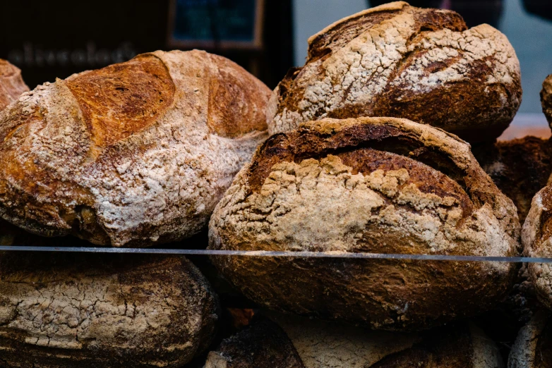 several round, uncooked breads sitting in a pile